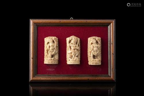 Three avory sculptures of Shiva, on a velvet panel, framed India, 19th century (6x3 cm.) This lot may be subject to Import/Export restrictions due to CITES regulations in some extra UE countries...