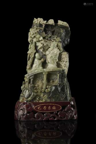 A large green hard stone carving depicting Huang Shi Gong and Zhang Liang on the bridge, on wood stand China, 20th century (h. 31 cm.)...