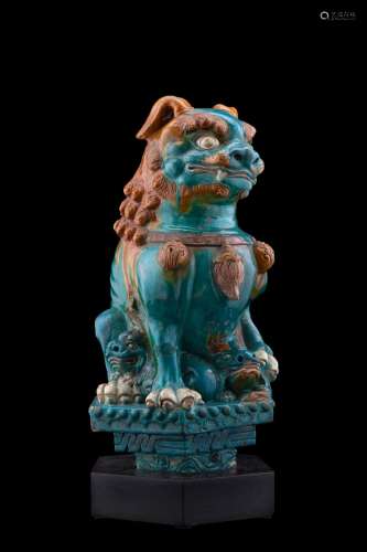A glazed earthenware figure of a Pho dog with two puppies, wood base (defects) China, Ming dynasty (1368-1644) Provenance Milanese private collection Gianni Russo Antiquities (h. 41 cm.)...