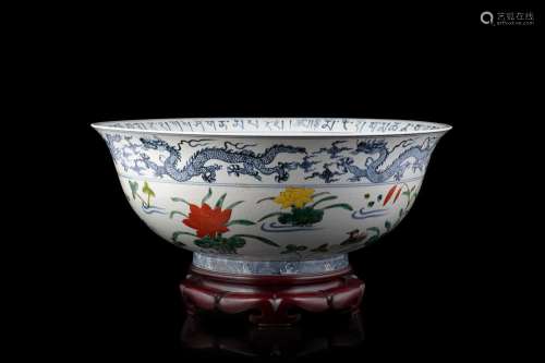 A large doucai bowl, decorated with blue and white dragons, polycrome flowers and ducks. The rim with archaic characters, a garden scene to the bottom, wood base China, 20th century Provenance Milanese private collection Gianni Russo Anti...