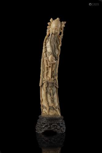 An ivory sculpture of Shoulao, on carved wood base China, early 20th century (h. 36 cm.) This lot may be subject to Import/Export restrictions due to CITES regulations in some extra UE countries...