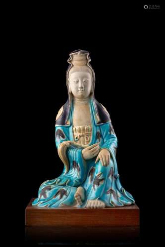 A turquoise and aubergine biscuit porcelain Guanyin, wood base China, Qing dynasty, 18th century (h. 25 cm.)...