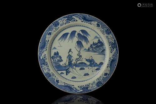 A large blue and white export plate, painted with figures in landscape (defects) China, Qing dynasty, Qianlong period (1736-1795) (d. 55.5 cm.)...