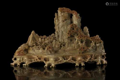 A large soapstone carving of rocky mountains with shrubs and pagodas China, late Qing dynasty (1644-1911) (37.5x22 cm.)...