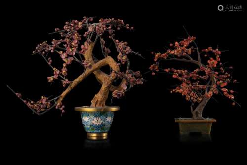 Two trees, one with coral leaves, the other with hard stones leaves, one with cloisonnÃ© base and the other with green hard stone China, early 20th century (h. max 40 cm.) This lot may be subject to Import/Export restrictions due to CITES ...