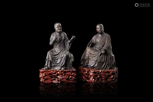 A pair of bronze model of Buddhist monks, with wood bases, with inscriptions mentioning the Buddhist temple of Zi Jin An (slight defects) China, late XIX/early XX century (h. 20.5 cm.)...