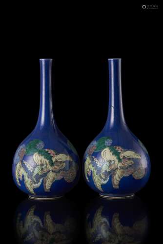 A pair of blue ground bottle vases decorated with polychrome buddhist lions (restorations) China, late Qing dynasty (1644-1911) (h. 43 cm.)...