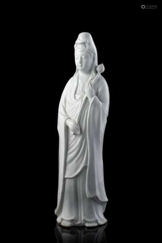 A blanc de chine standing Guanyin, holding a lotus flower (defects) China, 20th century Provenance Milanese private collection Gianni Russo Antiquities (h. 33.5 cm.)...