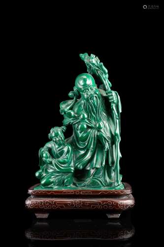 A malachite group of a sage with his accolyte, wood base China, 20th century (h. tot 18.2 cm.)...