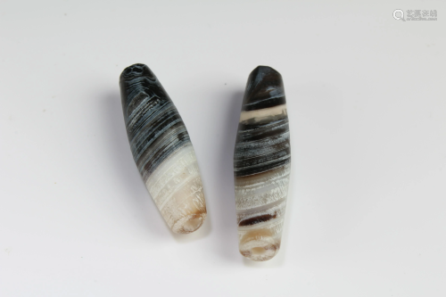 A Group of Two Tibetan 'First-Line' Dzi Beads
