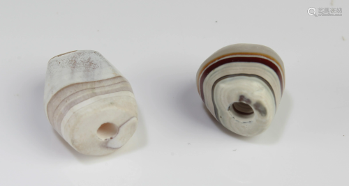 A Group of Two Tibetan 'First-Line' Dzi Beads