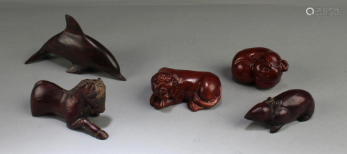 A Group of Five Carved Wooden Decorative Ornaments
