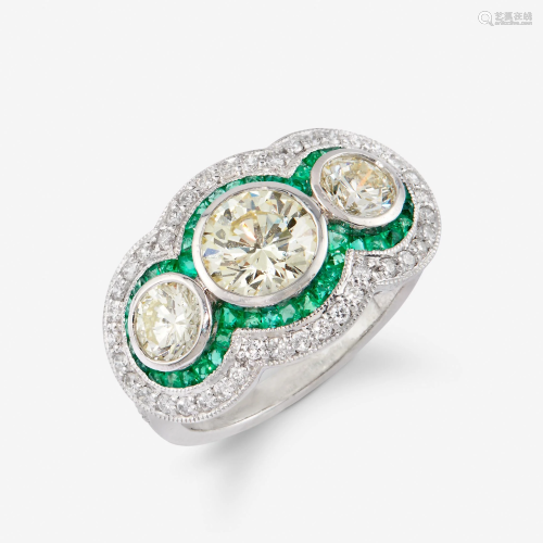 A diamond, emerald, and platinum ring,
