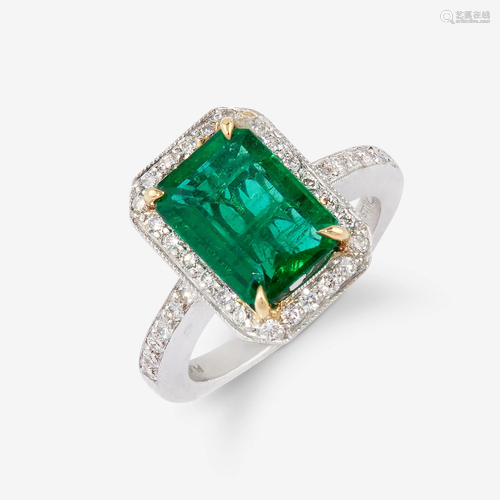 An emerald, diamond, and platinum ring,