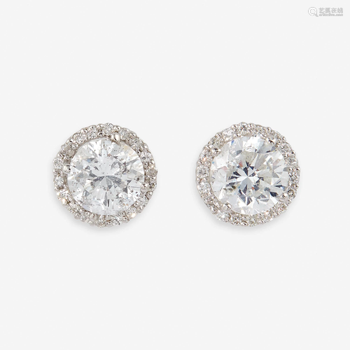 A pair of diamond and eighteen karat white gold stud