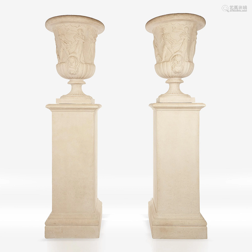 A pair of cast stone campana urns on pedestals, …