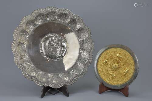 A Persian white metal dish with bronze and gilt mirror