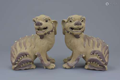 A pair of Chinese 19/20th C. Shiwan pottery dogs