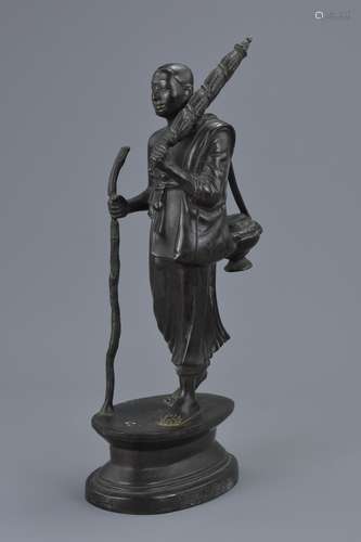 A Thai bronze figure of a travelling Monk