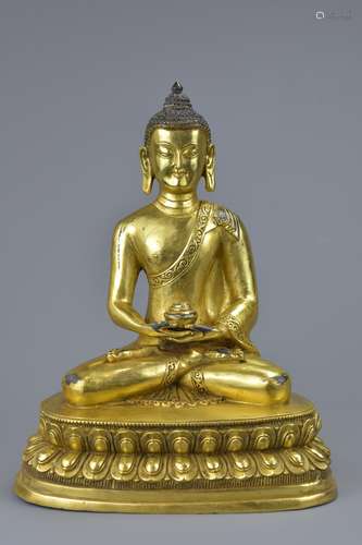 A 20th C. Tibetan gilt bronze figure of buddha Sakyamuni