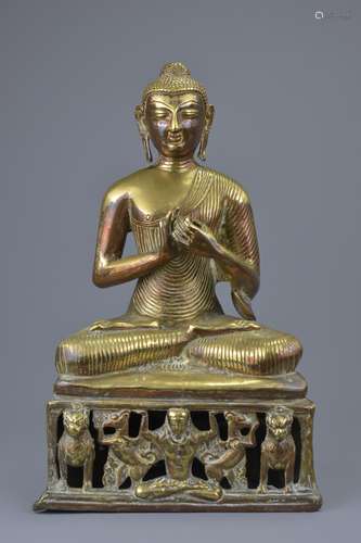 A South East Asian gilt copper figure of a seated Buddha