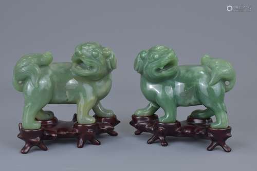 A pair of Chinese 19th C. carved jade lions on wooden stands