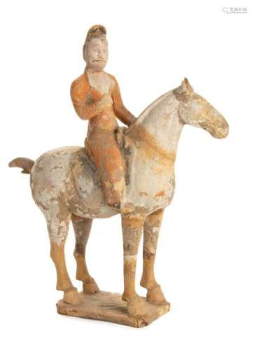 A PAINTED CERAMIC FUNERARY MODEL OF A HORSE AND RA…