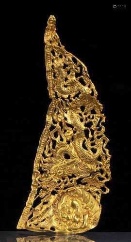 A GOLD ORNAMENT WITH A DRAGON AND A BUDDHIST LION …
