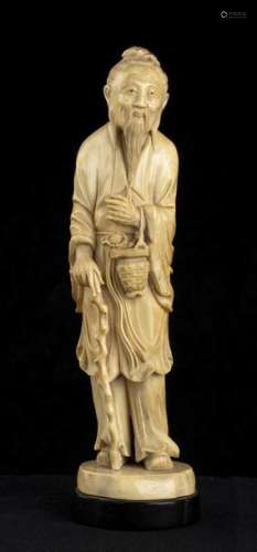 AN IVORY SCULPTURE OF A STANDING SAGE China, early…