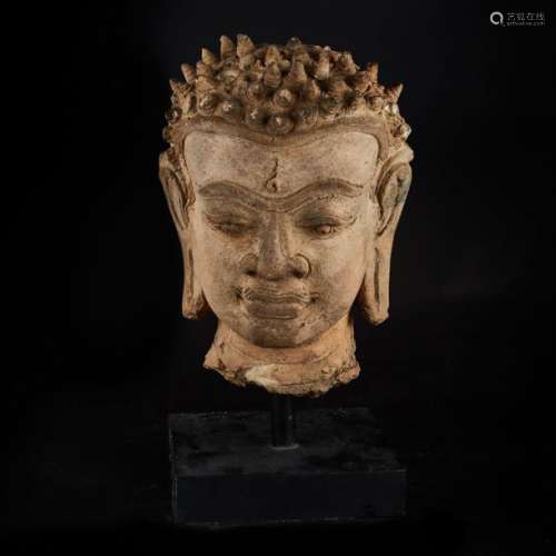 Terracotta Buddha head, the face sketching a sligh…