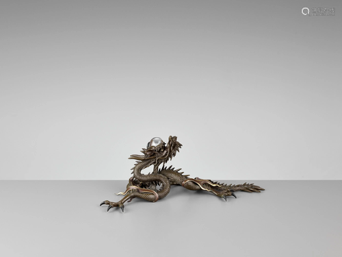 A BRONZE OKIMONO OF A DRAGON WITH ROCK …