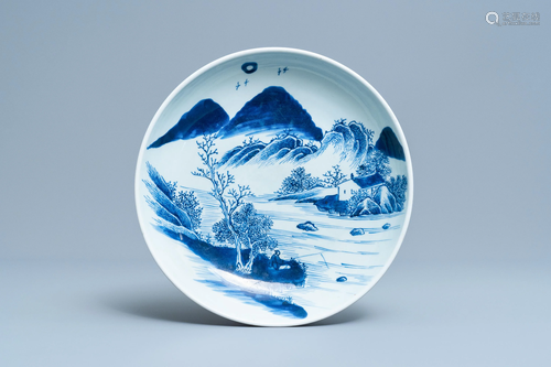 A Chinese blue and white charger with a fisher…