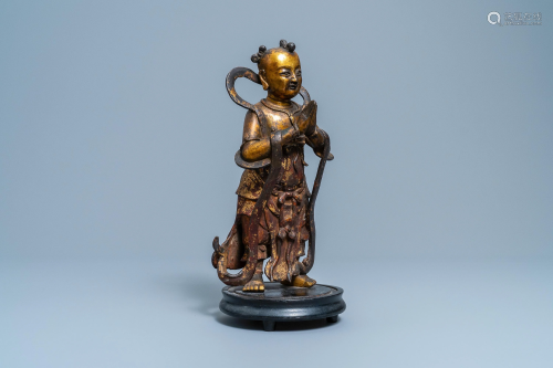 A Chinese lacquered and gilt bronze figure of a