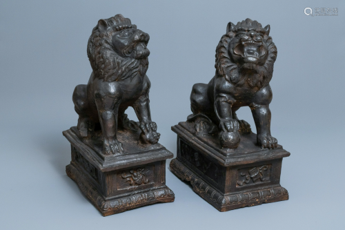 A pair of large Chinese cast iron models of lions, Ming