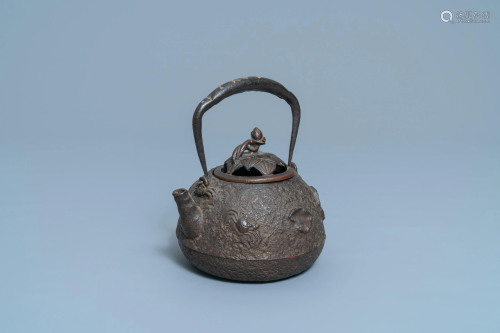 A Japanese cast iron 'tetsubin' teapot with shells and