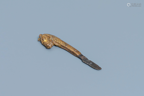 A Sino-Tibetan gilt bronze knife handle in the sh…