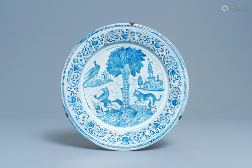 A blue and white dish with animals around a tree,