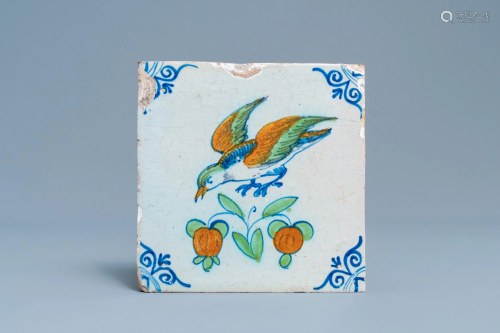 A polychrome Dutch Delft tile with a bird in flight,