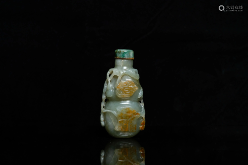 A Chinese gourd-shaped celadon and russet jade snuff