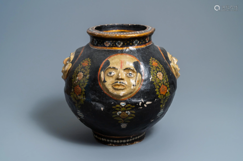A relief-decorated papier-mache vase with four …