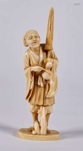 OKIMONO in ivory representing a character holding …