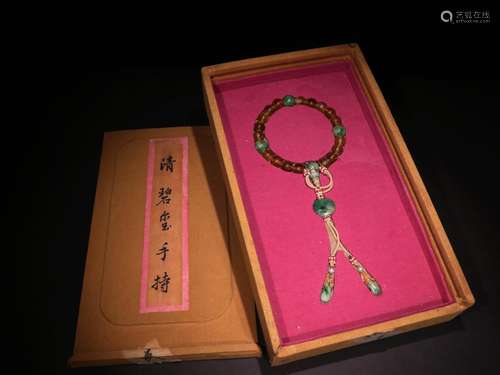 A QING DYNASTY TOURMALINE HAND STRING