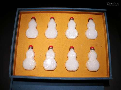 A GROUP OF QING DYNASTY WHITE JADE SPRING PALACE SNUFF BOTTLES