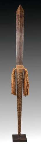 Large ceremonial club decorated with raffia or bra…