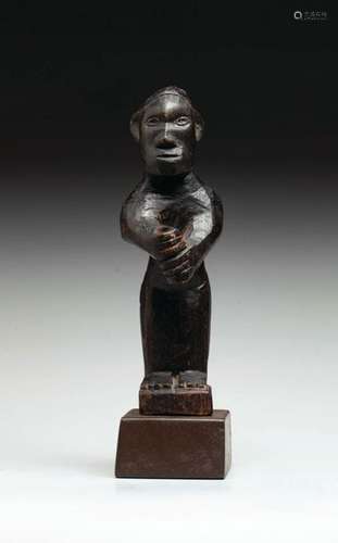 Statuette showing a figure holding a processional …