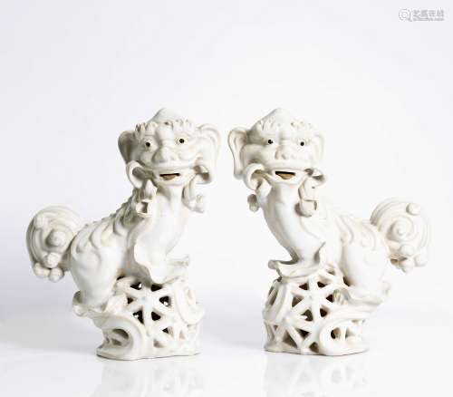 pair of =, Chinese, white glazed, porcelain Fu-dogs. Qing dyn.