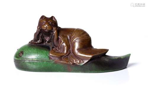 antique, Japanese netsuke, depicting a cat riding a tadpole. Early Showa