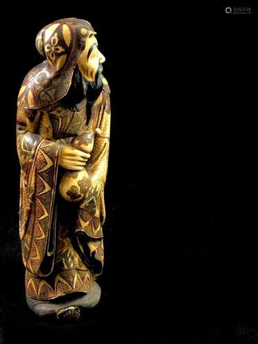 A polychrome ivory okimono representing a Chinese …