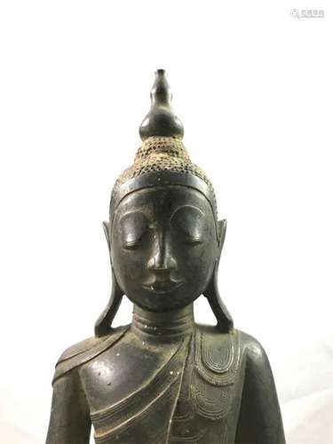 A bronze Buddha with brown patina, seated in medit…