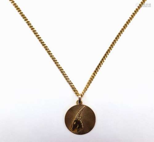 COLLIER en or jaune 18 K retenant une médaille orn…